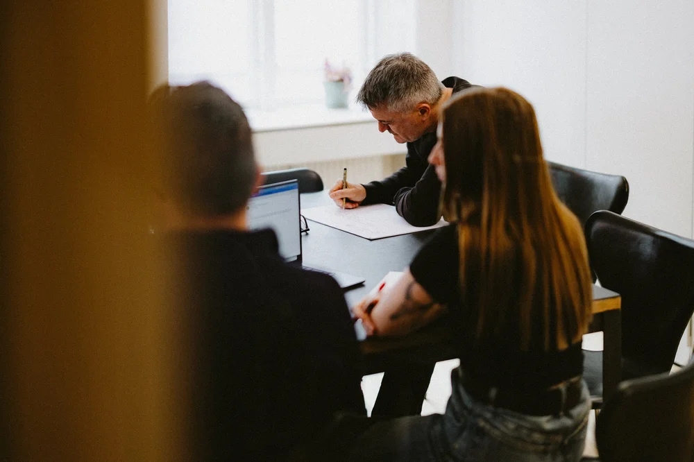 AdtomicAI team members meeting around a table